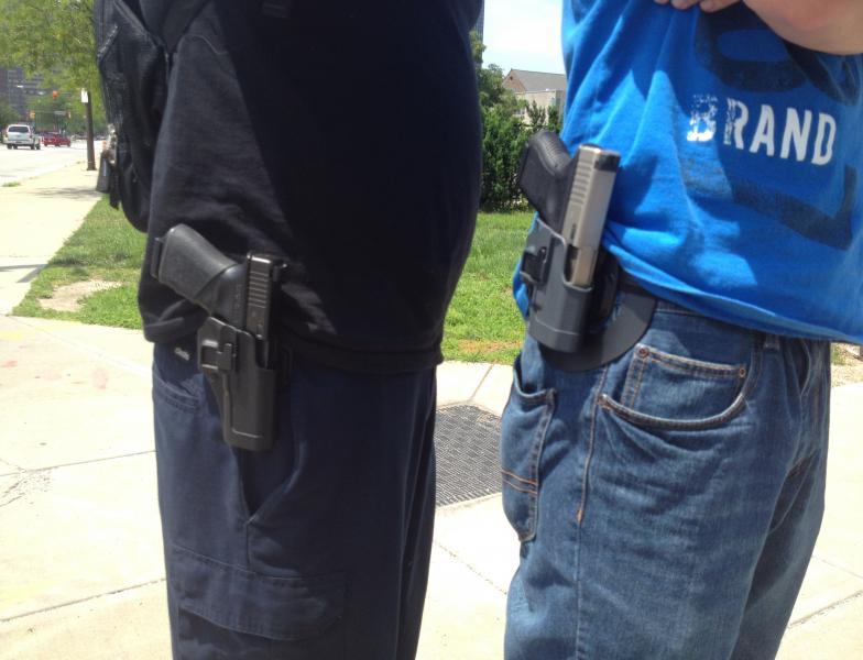 Reese McCracken and Matthew Chandler did not want to be photographed, but their sidearms -- and cash -- did the talking as they bought a half-dozen items from people who were headed to the buyback