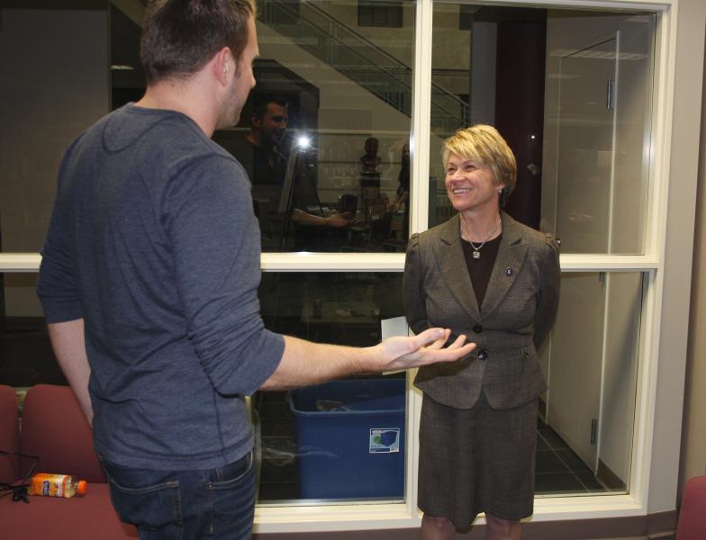 Marketing major Christopher Jones explains his team's concept for wearable tech to KSU president-elect Beverly Warren.