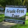 An anti-fracking yard sign stands up from the ground near the First Congregational Church in downtown Ravenna.