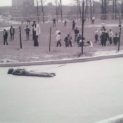 The students hunched over in the top right are attending to then-freshman Dean Kahler, moments after he was shot on May 4, 1970.