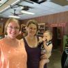 Volunteer Cindy Ducharme enjoys helping shopper Maryann Hutchins and her son Beau.