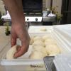 For naan, the Indian grill bread, the chef cuts 2 ounce pieces of dough and shapes them into the size of a salad plate. 
