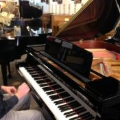 John Pellegrino gets ready to play a demonstration of a piano on the Pellegrino Music sales floor.