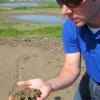 Jason Ziss holding sediment ideal for construction and filler material