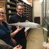 Amanda McGee, left, is collections manager, and Lee Hall is preparator in the museum's department of vertebrate paleontology. McGee holds a model of Cladoselache shark pursuing a Kentuckia hlavini fish. Both are based on fossils found in the I-71 dig.  